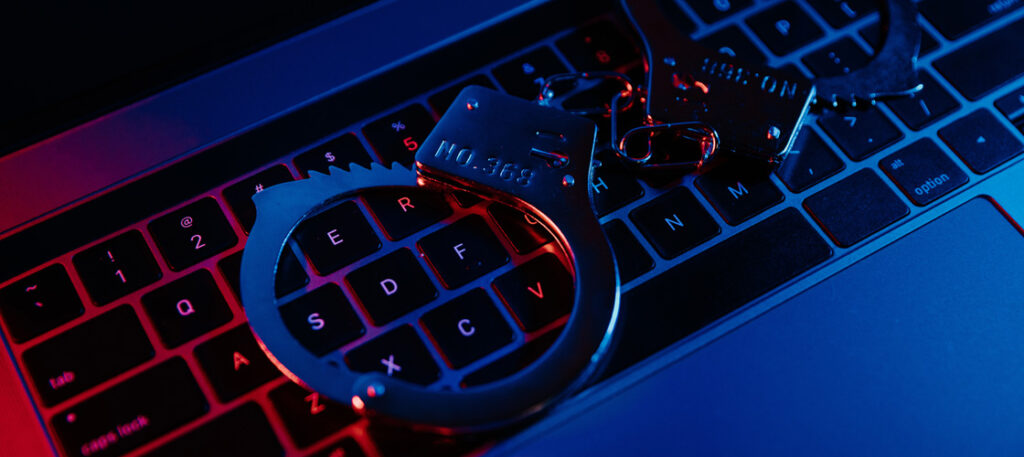 Picture of laptop keyboard with handcuffs on it