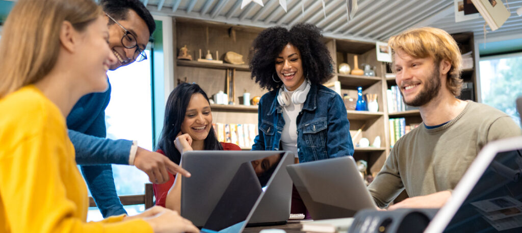 Picture of a group of young adults with computers